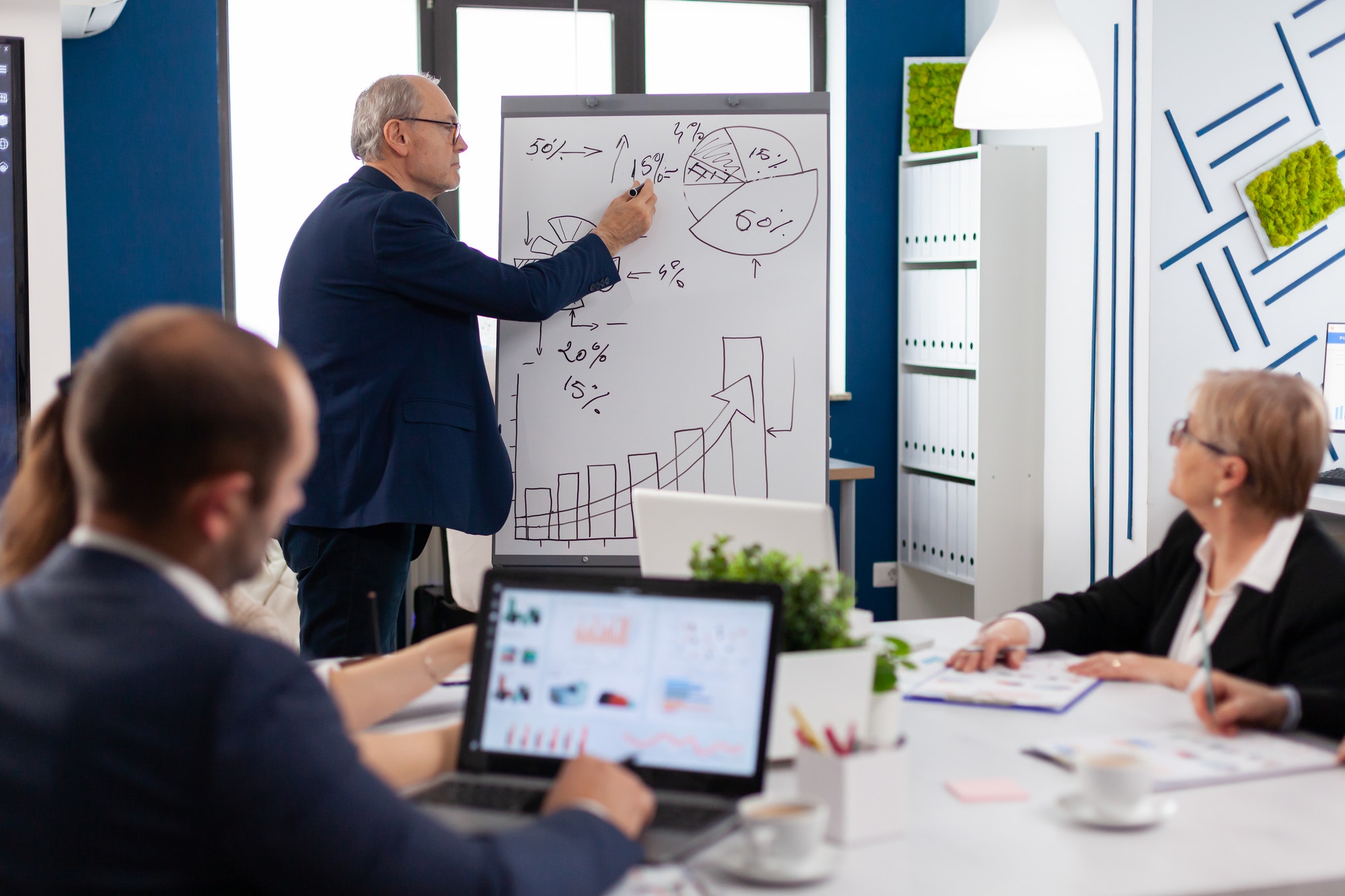 Confident man business coach giving flipchart presentation training